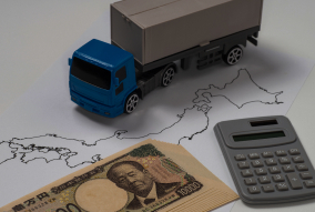 トラックと一万円札の画像